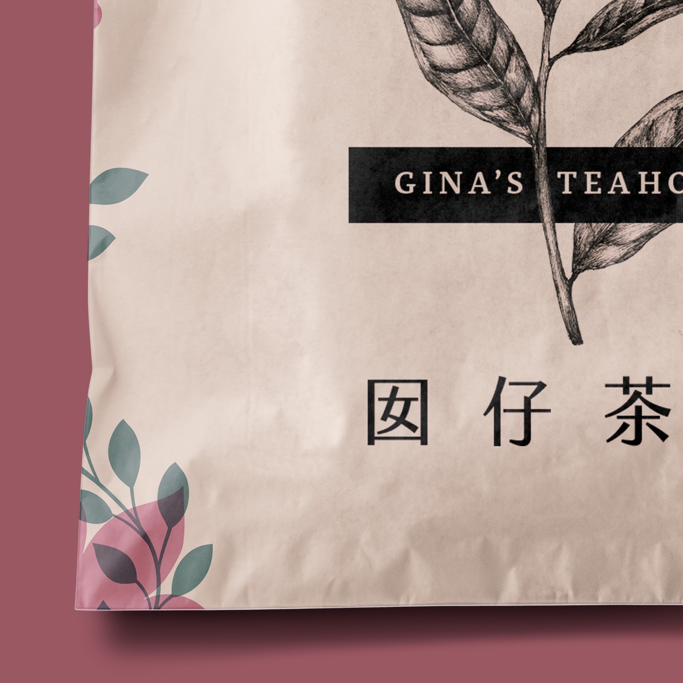 A mockup image of a light brown paper wrapping bag, such as for a cookie or pastry. On it is printed a logo reading 'Gina's Teahouse'.