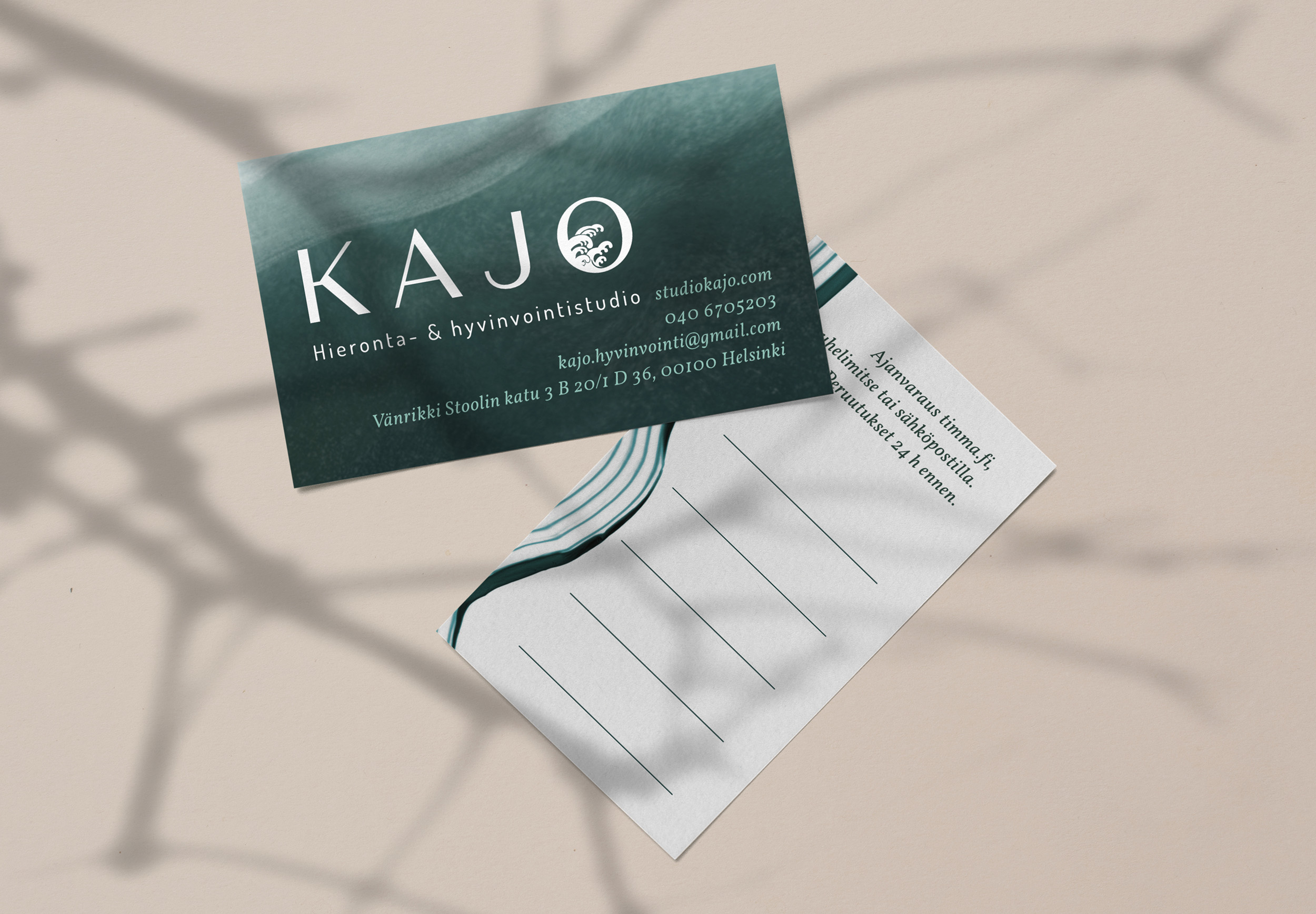Mockups of the front and back of the business card design on a peach-colored background.